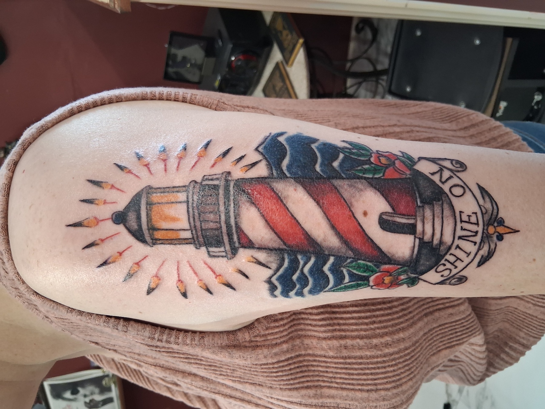 Traditional lighthouse tattoo by Tony Parisi
